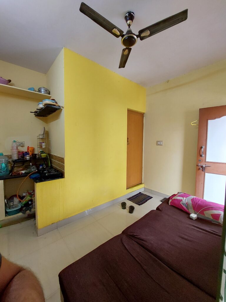 rk for men living room with cot , wardrobe and entrance door open