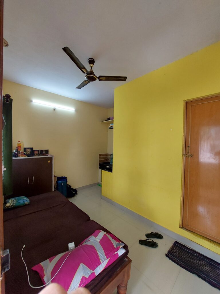 rk for men living room with cupboard and kitchen in one corner